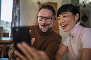 Diverse couple enjoying video call connection feeling strong emotion