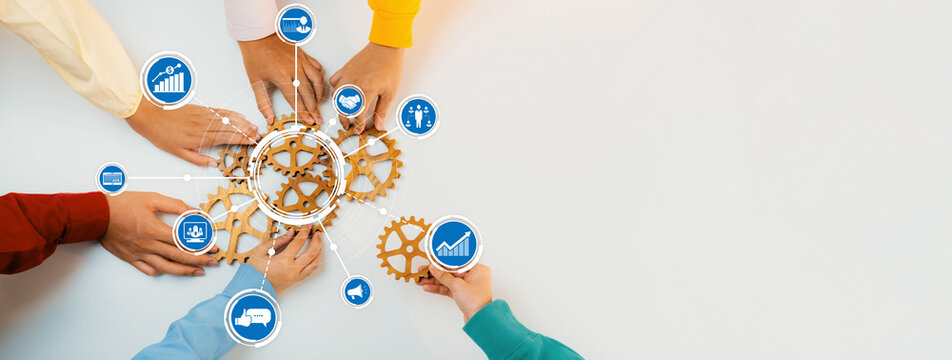 A dynamic display of hands collaborating on gears interspersed with icons, symbolizing teamwork and innovative business concepts in a modern office space. Amity
