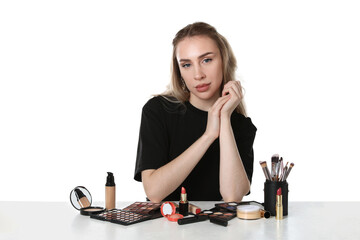 Makeup artist with tools and cosmetic products on white background