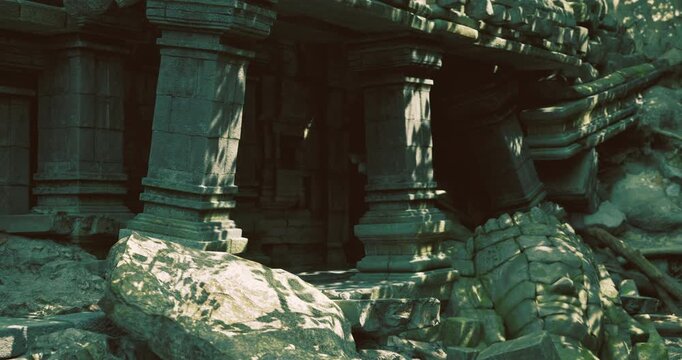 Crumbling stone columns and scattered boulders reveal the remnants of an ancient structure buried under mud and rocks after a significant landslide in a dense jungle area.