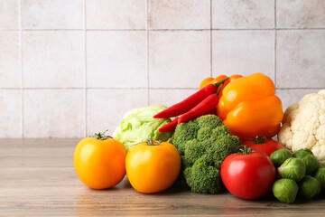 Different fresh raw vegetables on wooden table, closeup. Space for text
