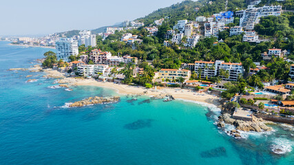 Conchas chinas beach with turquoise water and hillside resorts on a sunny day in mexico