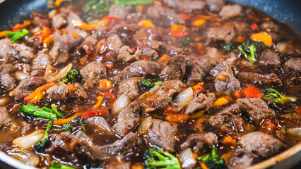 Beef cubes with broccoli, onions, and bell peppers bubbling in savory soy sauce. Smoking hot, perfect for rice bowls or main dish.