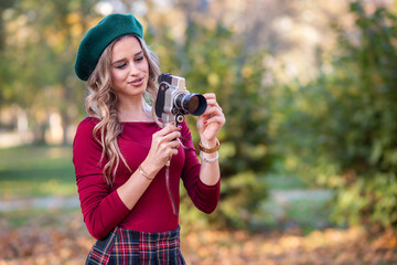 Pretty woman with vintage video camera