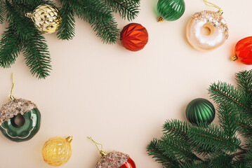 Christmas Donuts Ornaments and Pine Branches on Light Beige Background