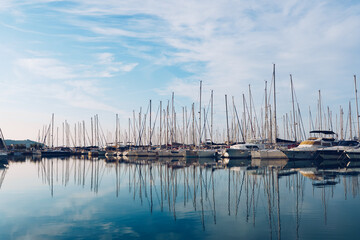 Calm Marina with Reflected Sailing Boats at Sunrise