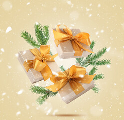 Gift boxes and snow flying in air on beige background. Merry Christmas and Happy Holidays card