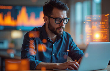 Young bearded man with glasses types on laptop keyboard, managing complex data. Works with advanced futuristic glowing holographic screens, dashboards. Displays show digital information, financial