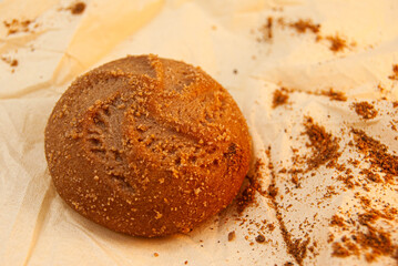 Freshly baked cookie on parchment paper with loose powder.