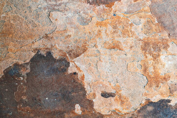 Detailed close-up of natural stone background, showcasing the organic patterns, textures, and mineral deposits.