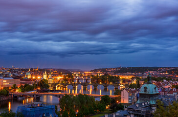 Fototapeta premium Scenic night view of Prague bridges at twilight. Manes, Charles, Legion and Jirasek bridges across the Vltava river. Downtown of Prague city, Czech Republic