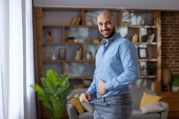Happy man celebrating weight loss success and healthy lifestyle