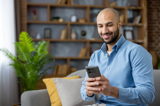 Young man enjoying social media on smartphone at home