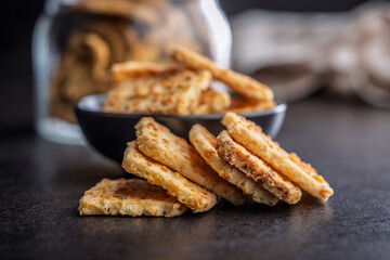 Crunchy salted crackers on black table.