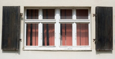 Weathered Wooden Shutters and Old Window Facade