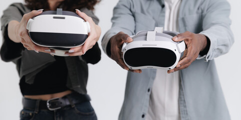 Asian female and African male engaging with virtual reality headsets closeup
