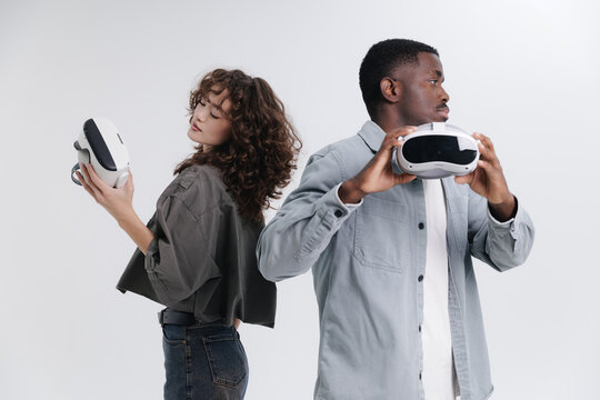 Multiethnic team with Fashion photo VR glasses technology. Young diverse adults engaging with virtual reality headsets