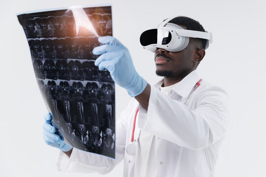 African male doctor examines Mri scan revealing spinal with vr headset in modern medical setting. Concept AI Assistant in medical data analysis