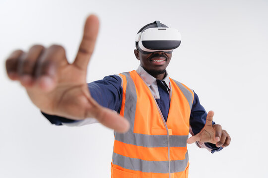 African American male adult using vr headset in construction safety vest touches virtual interface