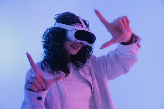 Asian young female enjoying virtual reality experience with vr headset. Concept modern immersive digitalization and technology