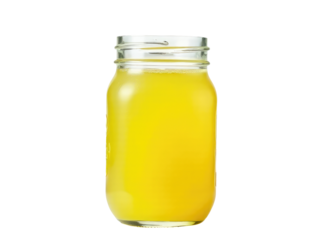 A clear glass jar filled with a translucent liquid sits on a wooden table
