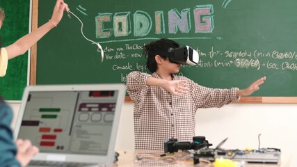 Boy wearing VR headset to enter metaworld at table with electronic board while girl coding system. Group of diverse student working together to develop program and writing engineering code. Pedagogy. - Powered by Adobe