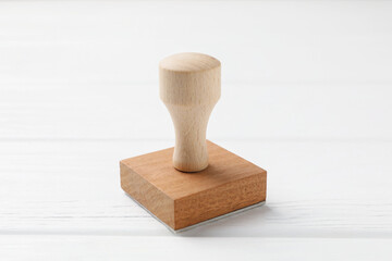One wooden stamp on white table, closeup