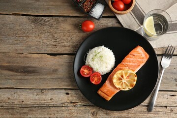 Piece of tasty grilled salmon with rice served on wooden table, flat lay. Space for text