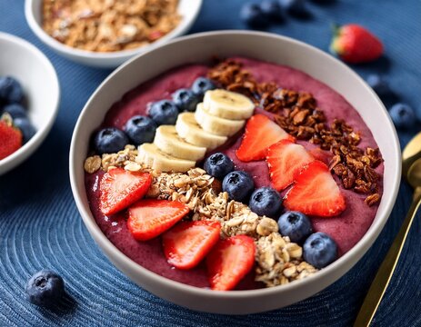 delicious acai bowl with strawberries blueberries banana and granola