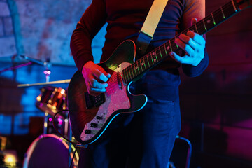Naklejka premium Man playing electric guitar on stage, closeup