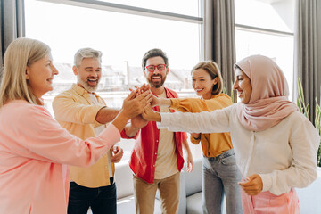 Diverse group of multinational businesswomen and businessmen having teamwork in modern office