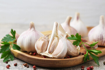 Garlic, peppercorns and parsley on light table, closeup