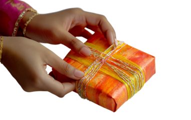 Hands at work wrapping holiday gifts for Diwali with handmade paper emphasizing attention to detail and presentation isolated on transparent background PNG