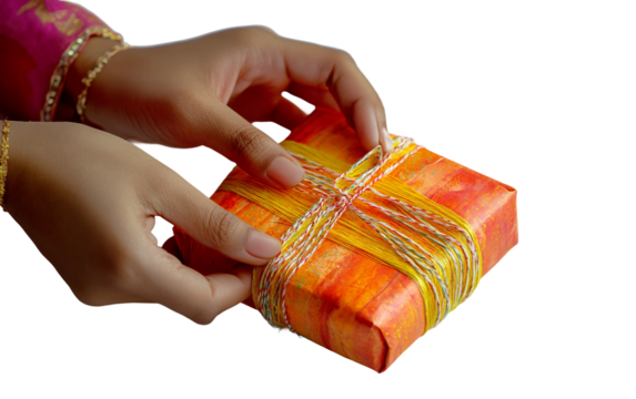 Hands at work wrapping holiday gifts for Diwali with handmade paper emphasizing attention to detail and presentation isolated on transparent background PNG