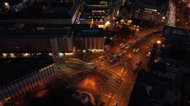 night time illuminated munich city center traffic street square tram station aerial panorama 4k germany