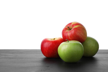 Red and green ripe apples on wooden table against white background