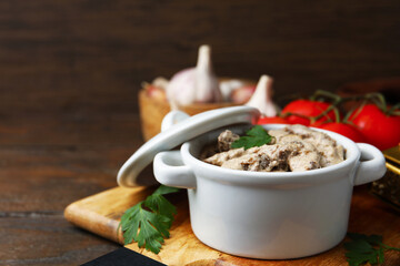 Tasty beef stroganoff with parsley served on wooden table, closeup. Space for text