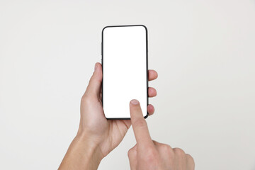 Man holding smartphone with blank screen on white background, closeup. Mockup for design