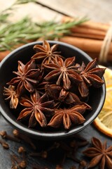 Mulled wine spices. Anise stars in bowl on table, closeup