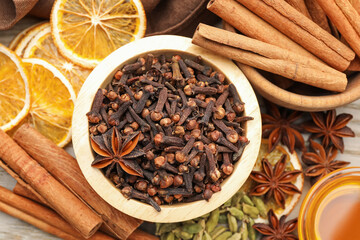 Different spices, dry orange slices and honey for mulled wine on table, flat lay