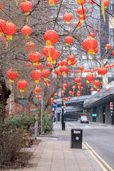 Manchester, uk, January 19th 2025 Red Chinese new year lanterns with yellow tassels decorate a park scene, creating a festive, cultural atmosphere.