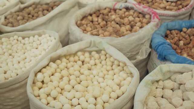 Assortment of Kashk, Qurut, Chortan, Qurt and Aaruul at eco market hard cheese found in Central Asia and the Middle East. Various qurut on the counter. Fermented dried yogurt balls traditional