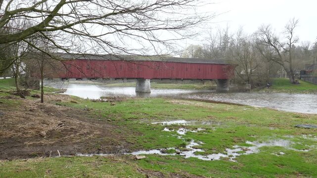 West Montrose Covered Bridge, the "Kissing Bridge", the oldest wooden covered bridge in Ontario, Canada. Crossing the Grand river, built in 1880. Shot on a rainy day in 2018.