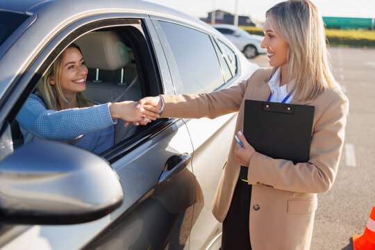 Instructor Congratulating Learner Driver after Practical Driving Exam - Powered by Adobe