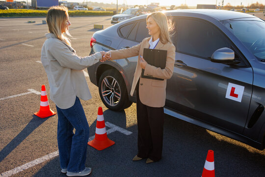Learner Driver Shaking Hands with Instructor After Passing Driving Test - Powered by Adobe