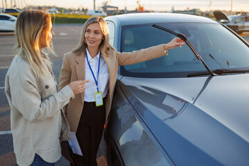 Driving instructor explaining car features to learner during practical lesson