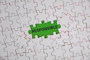 A white puzzle highlighting the word "RESPONSIBLE" on an green background. Conveying themes of accountability, teamwork, and problem solving.