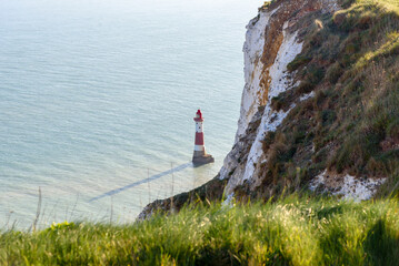 View of Beachy Head lighhouse form the top of a cliff at sunset in spring