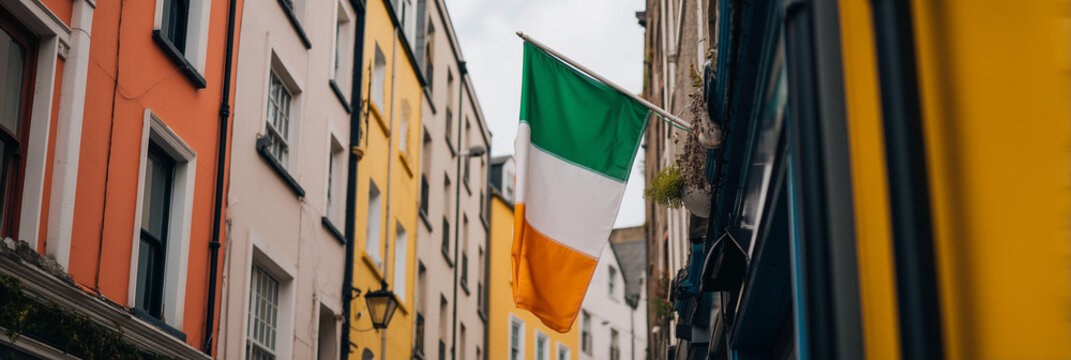 Irish flag waving in a charming alley surrounded by vibrant colorful buildings, festive concept of travel agency or cultural heritage