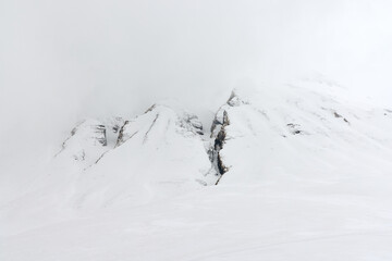 Snowy mountain peaks and clouds fill the scene, showcasing the harsh environment of the Himalayas during a trek to Annapurna Base Camp in Nepal.